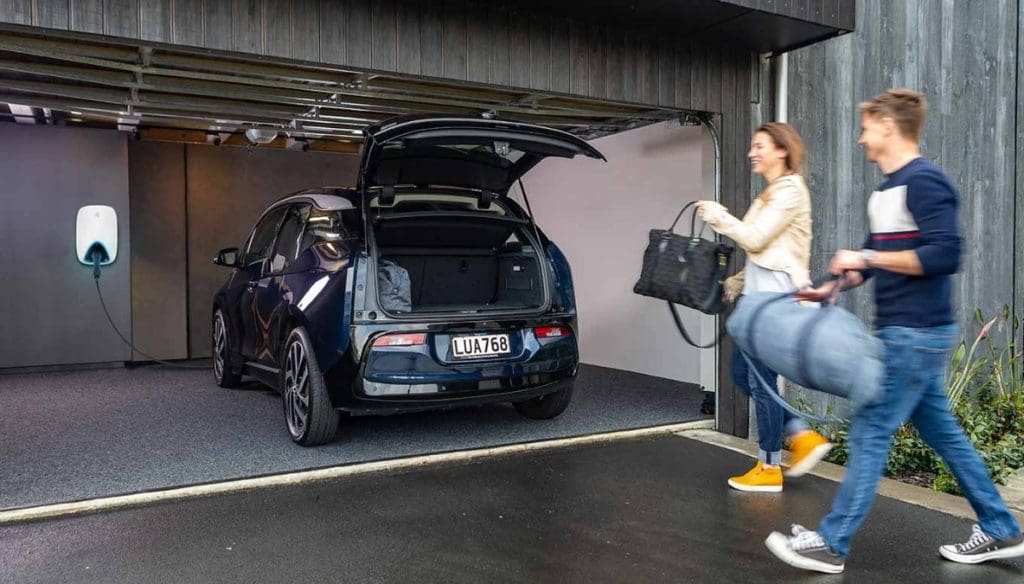 Couple walking to car that is pulled into a Schneider EV Charger